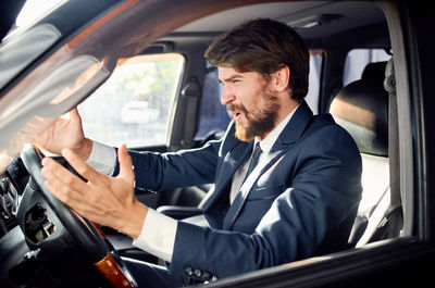 Portrait of man sitting in car