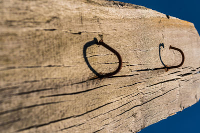 Close-up of text on wood against wall