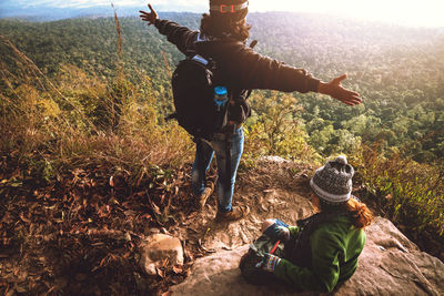 Rear view of man with arms raised