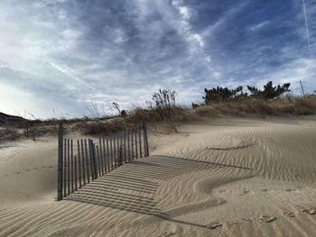 Empty road against cloudy sky