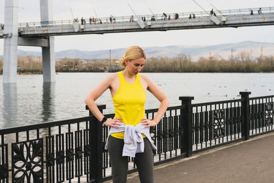 Full length of woman standing on bridge