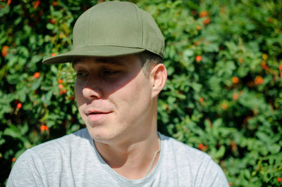 Close-up of mid adult man standing by plants at park