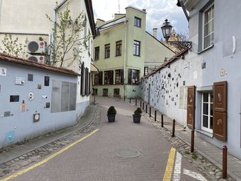 Empty alley amidst buildings in city