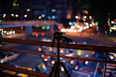 Close-up of illuminated railing in city at night