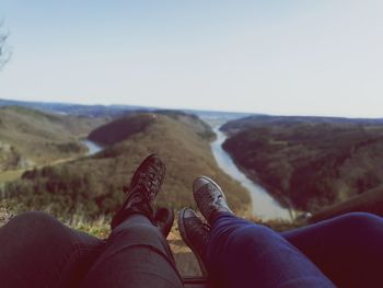 Low section of man legs against clear sky