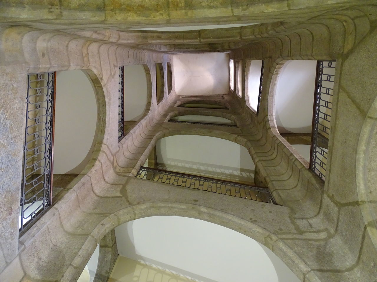 CLOSE-UP OF HAND ON ARCHED CORRIDOR