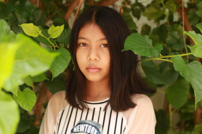 Portrait of teenage girl with leaves