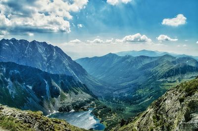 Scenic view of mountains against cloudy sky