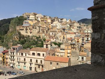 Buildings in town against sky