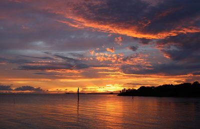 Scenic view of sea against romantic sky at sunset