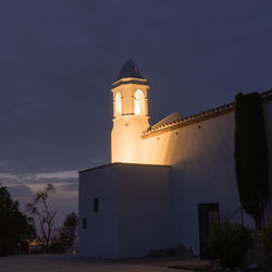 Low angle view of illuminated building against sky at night