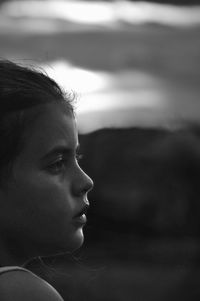 Close-up portrait of young woman looking away