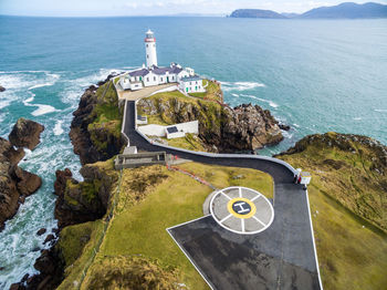 High angle view of lighthouse by sea against sky