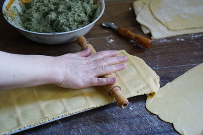 Close-up of woman preparing food on cutting board