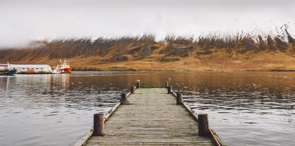 Pier over lake against sky