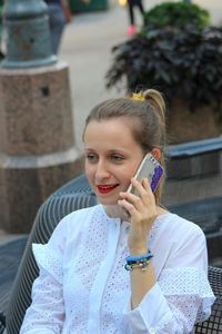 Young woman using mobile phone outdoors