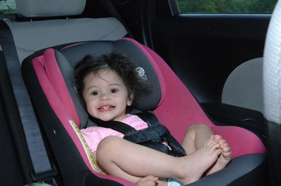 Portrait of cute girl in car