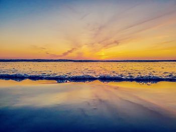 Scenic view of beach against sky during sunset