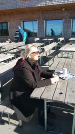 Woman sitting on chair at table