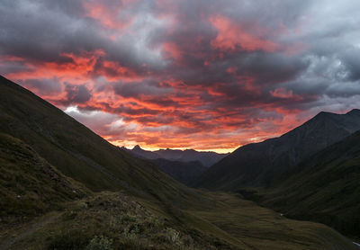 Scenic view of mountains against dramatic sky