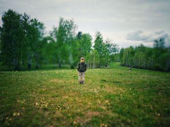 Full length of man standing on field against sky