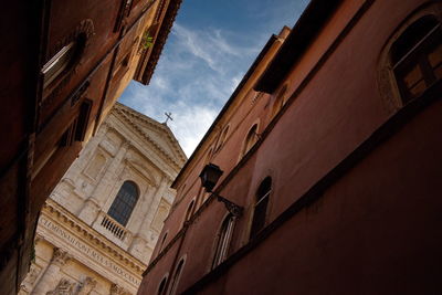 Low angle view of church and buildings against sky