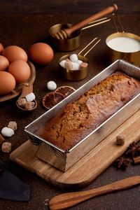 Loaf of bread with various ingredients on table