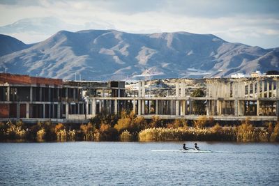 Scenic view of lake and mountains against sky