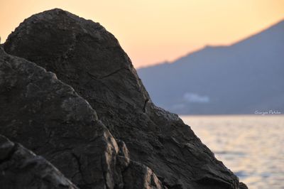 Rock formation against sky during sunset