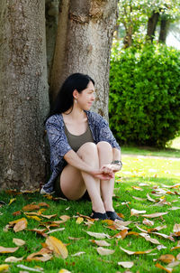 Portrait of young happy brunette asian woman relaxing in city, park. summer vacation. travel