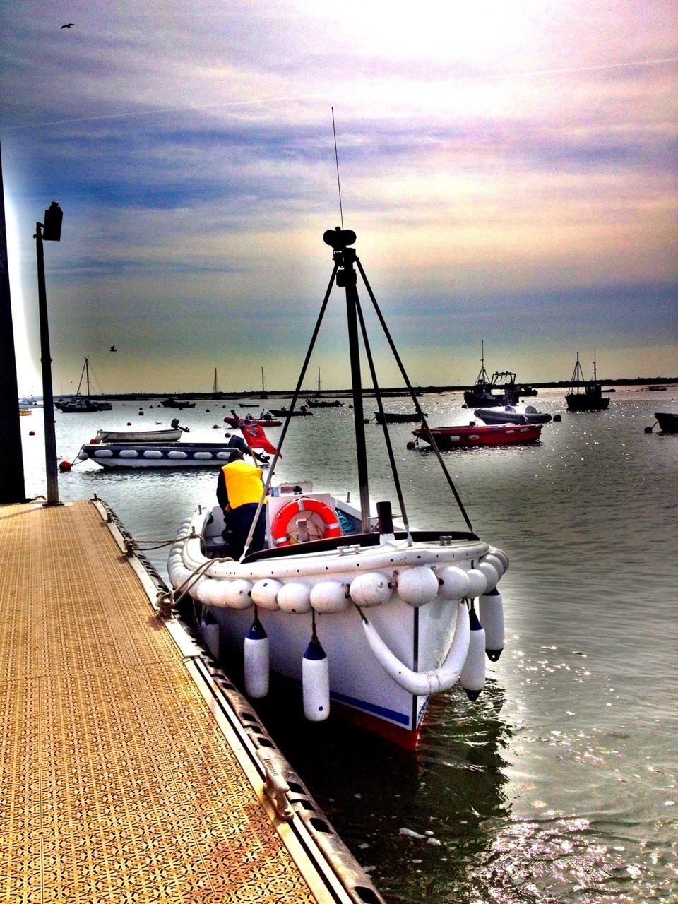 nautical vessel, transportation, boat, mode of transport, water, sea, moored, sky, cloud - sky, cloud, pier, cloudy, mast, travel, harbor, nature, waterfront, outdoors, sailboat, day