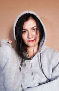 Portrait of young woman wearing hooded shirt 