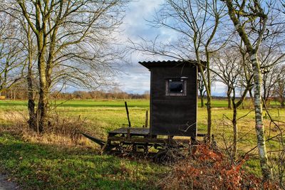 Abandoned house on field against sky