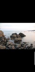 Rocks on beach against sky