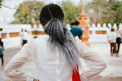 Rear view of woman walking in park during winter