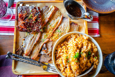 Grilled ribs and prok belly striped served with sauce and java rice.