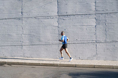 Full length of man running on wall