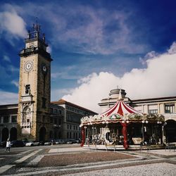 Clock tower in city against sky