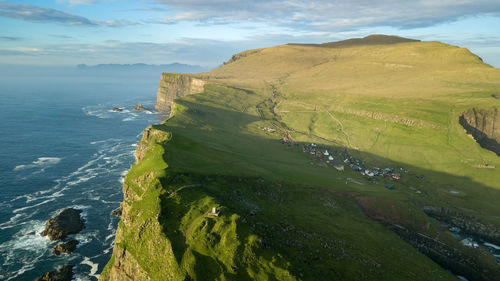 Scenic view of sea and mountains against sky