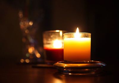 Close-up of illuminated tea light candle on table