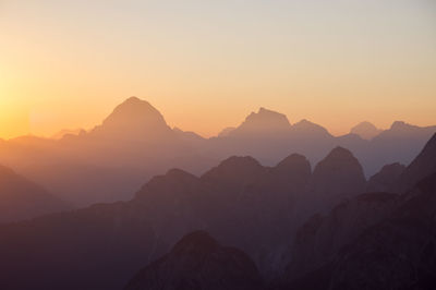 Sunrise  silhouette mountain view from krniska glavica / iof di sompdogna