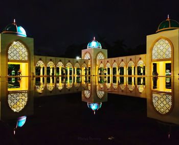 Illuminated building against sky at night