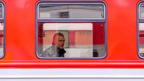 Portrait of man sitting in train