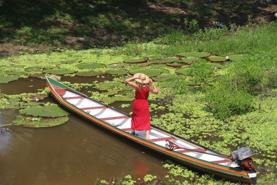 Rear view of man kayaking in lake