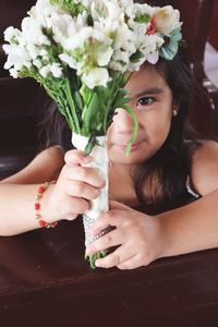 Close-up of woman holding flower bouquet