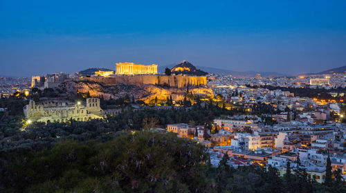 High angle view of illuminated buildings in city