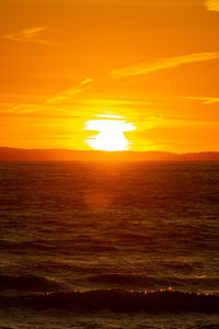 Scenic view of sea against romantic sky at sunset