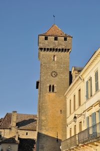 Low angle view of buildings against clear blue sky