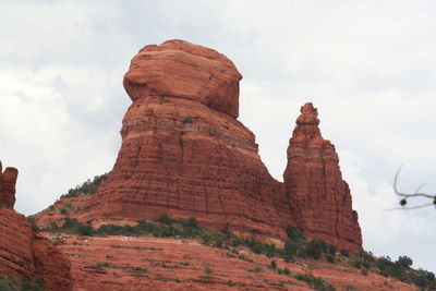 Low angle view of rock formation against sky