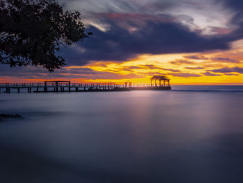 Scenic view of sea against orange sky
